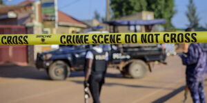 Police officers at a crime scene in Uganda