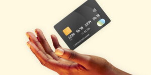 A person holding an ATM card