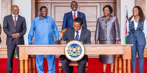 Labour Cabinet Secretary Alfred Mutua signing the gazette notice on a 6 per cent minimum wage increase on November 1, 2024.